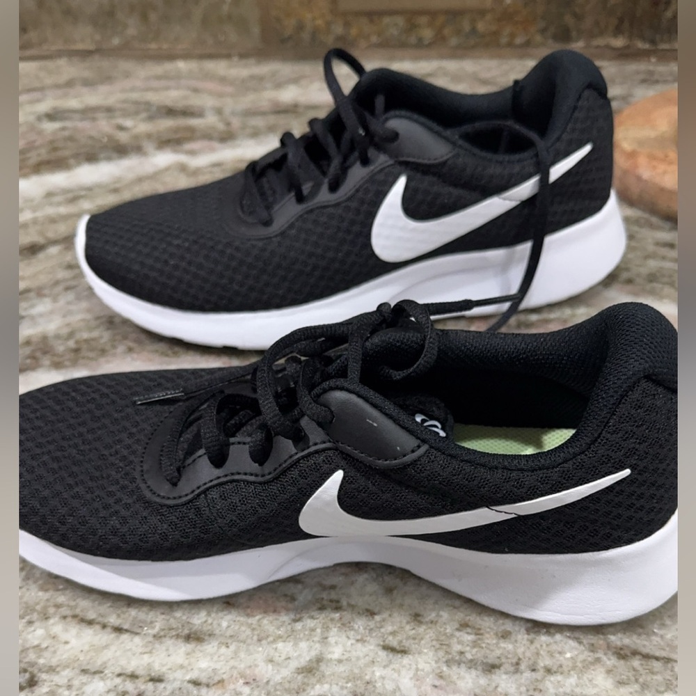 Black and white Nikes. Size 9 (women) worn literally one time